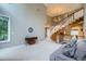 Spacious living room featuring a staircase, large windows, neutral colors, and a chandelier at 7355 Nile St, Arvada, CO 80007