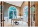 Stylish home office boasting a vaulted ceiling and bright arched windows at 7355 Nile St, Arvada, CO 80007