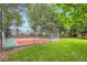Outdoor sport court surrounded by lush greenery and tall trees at 7355 Nile St, Arvada, CO 80007