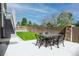 Fenced backyard with a lawn and patio with outdoor dining set, perfect for entertaining and relaxation at 3421 E 143Rd Dr, Thornton, CO 80602