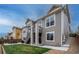 Backyard view with deck, stairway, and a stone patio with outdoor furniture and lawn at 3421 E 143Rd Dr, Thornton, CO 80602
