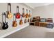 Spacious basement showcasing guitars displayed on wall and a row of amps at 3421 E 143Rd Dr, Thornton, CO 80602