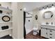 Modern bathroom featuring a shower, toilet, sink with mirror, and storage shelves at 3421 E 143Rd Dr, Thornton, CO 80602