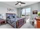 Bright bedroom with a large window, ceiling fan, and neutral decor at 3421 E 143Rd Dr, Thornton, CO 80602