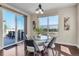 Modern dining area featuring a glass table, chairs, and sliding glass doors to the outdoor deck at 3421 E 143Rd Dr, Thornton, CO 80602