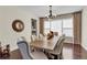 Formal dining room with large window, decorative chandelier, and seating for eight at 3421 E 143Rd Dr, Thornton, CO 80602