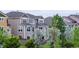 View of the building, with a fenced backyard, grass, and patio with outdoor dining set at 3421 E 143Rd Dr, Thornton, CO 80602