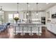 Bright kitchen with white cabinets, granite countertops, stainless steel appliances, and pendant lighting over the island at 3421 E 143Rd Dr, Thornton, CO 80602