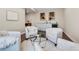 Stylish sitting room with white walls, hardwood floors, a bar, and four white chairs at 3421 E 143Rd Dr, Thornton, CO 80602