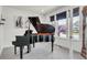 Bright sitting room with black grand piano, neutral walls, and ample natural light from a nearby window at 3421 E 143Rd Dr, Thornton, CO 80602