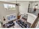 Open-concept living room with high ceilings, large windows, and hardwood floors at 3421 E 143Rd Dr, Thornton, CO 80602