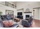 Spacious living room with tall ceilings, a large mirror, fireplace, and comfortable leather furniture at 3421 E 143Rd Dr, Thornton, CO 80602