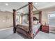 Spacious main bedroom with a luxurious four-poster bed, soft carpet, recessed lighting, and a serene atmosphere at 3421 E 143Rd Dr, Thornton, CO 80602