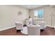 Cozy sitting room with light walls, dark wood floors, and 4 comfortable chairs at 3421 E 143Rd Dr, Thornton, CO 80602