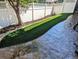 Well-maintained backyard with a strip of artificial turf and decorative concrete at 693 Syracuse St, Denver, CO 80230