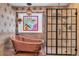 Elegant bathroom featuring a copper tub, a decorative window, and a modern shower with glass doors at 693 Syracuse St, Denver, CO 80230