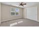 This bedroom features a ceiling fan, a window with shutters, and a closet with paneled doors at 693 Syracuse St, Denver, CO 80230
