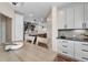 Bright and airy dining area with an open concept design, wood floors and white cabinetry at 693 Syracuse St, Denver, CO 80230