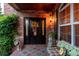 Inviting front entry with a black door, brick facade, and stylish decor at 693 Syracuse St, Denver, CO 80230