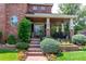 Charming front porch with brick stairs and beautiful landscaping at 693 Syracuse St, Denver, CO 80230