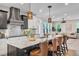Modern kitchen with stainless steel appliances, granite counters and barstool seating at 693 Syracuse St, Denver, CO 80230