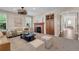 A well-decorated living room features stylish seating, modern decor, and a unique fireplace with decorative tile at 693 Syracuse St, Denver, CO 80230