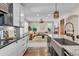An open-concept living room and kitchen layout with a seamless flow, abundant natural light, and hardwood floors at 693 Syracuse St, Denver, CO 80230