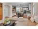 A living room and kitchen layout features wood floors, stylish seating, and an open concept design at 693 Syracuse St, Denver, CO 80230