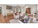 Spacious living area with staircase, hardwood floors, and cozy seating at 693 Syracuse St, Denver, CO 80230