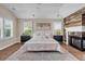 Spacious main bedroom boasts a decorative fireplace, plantation shutters, and warm hardwood floors at 693 Syracuse St, Denver, CO 80230