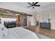 Open main bedroom with wood floors, fireplace, and views into a wet bar, bathroom and stairs at 693 Syracuse St, Denver, CO 80230
