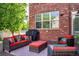 Inviting outdoor patio featuring stylish seating, a grill, and red brick architecture at 693 Syracuse St, Denver, CO 80230