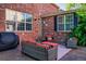 An outdoor patio features cushioned seating, outdoor grill, and a lush garden at 693 Syracuse St, Denver, CO 80230