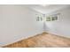 Bright bedroom with hardwood floors and natural light from two large windows at 107 S Windsor Dr, Denver, CO 80219