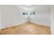 Clean bedroom with painted walls, hardwood floors, and two windows for natural light at 107 S Windsor Dr, Denver, CO 80219