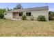 Charming single-story home with a well-manicured lawn and classic covered front porch with large windows at 107 S Windsor Dr, Denver, CO 80219