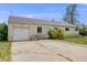 Cozy single-story home featuring a convenient attached garage and easy access driveway at 107 S Windsor Dr, Denver, CO 80219