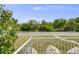 A tranquil view from the porch with a manicured lawn and lush greenery at 107 S Windsor Dr, Denver, CO 80219