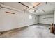 Spacious empty garage with concrete floor and overhead lighting at 107 S Windsor Dr, Denver, CO 80219