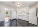 Bright kitchen with all-white appliances, cabinets, contrasting tile floor at 107 S Windsor Dr, Denver, CO 80219