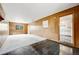 Spacious living room with wood paneling, contrasting flooring and window at 107 S Windsor Dr, Denver, CO 80219