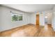 Bright, light-filled room with hardwood floors, painted walls, with several windows and doorways to other rooms at 107 S Windsor Dr, Denver, CO 80219
