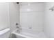Bathroom featuring white tile tub/shower combo at 19043 E 58Th Ave, Denver, CO 80249