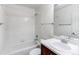 Full bathroom featuring a shower-tub combo, a vanity with storage, and a mirror at 19043 E 58Th Ave, Denver, CO 80249