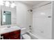 Bathroom featuring white tile tub/shower combo and wooden vanity at 19043 E 58Th Ave, Denver, CO 80249