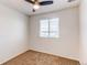 Bedroom with neutral carpet, white walls, a ceiling fan, and a window providing natural light at 19043 E 58Th Ave, Denver, CO 80249