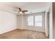 Bedroom features a ceiling fan and windows with bright natural light at 19043 E 58Th Ave, Denver, CO 80249