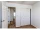 Bedroom with a large closet, neutral carpet, and an open view to the hallway at 19043 E 58Th Ave, Denver, CO 80249