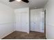 Carpeted bedroom showing closet doors and access to another room at 19043 E 58Th Ave, Denver, CO 80249