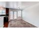 Bright dining area featuring neutral carpet and a sliding glass door to the deck at 19043 E 58Th Ave, Denver, CO 80249